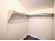 Angled walk-in closet features white walls, dark baseboards and hardwood floors at 3920 Legend Hills St # 202, Las Vegas, NV 89129