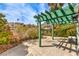 Inviting back patio with green pergola and view of community green space at 4043 Chalfont Ct, Las Vegas, NV 89121