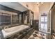 Luxurious bathroom featuring a large soaking tub, decorative tile, and separate glass shower at 4043 Chalfont Ct, Las Vegas, NV 89121