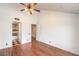 Spacious bedroom with hardwood floors, an open door to an en-suite, and a ceiling fan at 4043 Chalfont Ct, Las Vegas, NV 89121