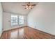 Bright bedroom featuring hardwood floors and two windows offering natural light at 4043 Chalfont Ct, Las Vegas, NV 89121