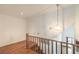 Upstairs hallway with hardwood floors and decorative light fixture at 4043 Chalfont Ct, Las Vegas, NV 89121