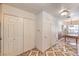 Hallway with tile floors, coat closets, and dining area with windows at 4043 Chalfont Ct, Las Vegas, NV 89121