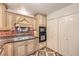 Close up of kitchen featuring cream cabinets, granite countertops, and stainless steel appliances at 4043 Chalfont Ct, Las Vegas, NV 89121