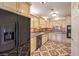 Bright kitchen with cream cabinets, black appliances, and decorative tile flooring at 4043 Chalfont Ct, Las Vegas, NV 89121