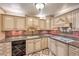 Well-lit kitchen with cream cabinets, decorative backsplash, and granite countertops at 4043 Chalfont Ct, Las Vegas, NV 89121