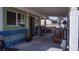 View of the covered back patio with exercise equipment, pots and sliding door at 4432 Faberge Ave, Las Vegas, NV 89115