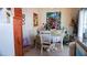 Cozy dining area with a round table, white chairs, and natural light at 4432 Faberge Ave, Las Vegas, NV 89115