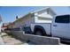 Exterior side view of the home with a white truck parked out front at 4432 Faberge Ave, Las Vegas, NV 89115
