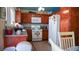 Functional kitchen with wood cabinets, white appliances, and tiled floors at 4432 Faberge Ave, Las Vegas, NV 89115