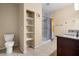 Bathroom with tile floors, shower, granite counters, and shelves at 4669 E Saint Louis Ave, Las Vegas, NV 89104