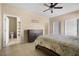 Bright primary bedroom with tile floors, a ceiling fan, and ensuite bathroom at 4669 E Saint Louis Ave, Las Vegas, NV 89104