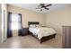 Cozy bedroom with a ceiling fan, tile floors, and large window at 4669 E Saint Louis Ave, Las Vegas, NV 89104