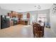 Open kitchen and dining area with tile floors, wood cabinets, and modern appliances at 4669 E Saint Louis Ave, Las Vegas, NV 89104