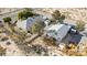 Aerial perspective showcases the property's layout with two houses, sheds, landscaping, and large outdoor space at 4838 N Tioga Way, Las Vegas, NV 89149