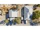Overhead view of two houses with gray roofs, sheds, and several parked vehicles on a spacious lot at 4838 N Tioga Way, Las Vegas, NV 89149