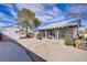 Backyard with gravel landscaping, covered patio, and a storage shed at 4838 N Tioga Way, Las Vegas, NV 89149