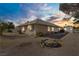 Back of the house with a small yard, a shed, and an outdoor fire pit, offering a rural charm at 4838 N Tioga Way, Las Vegas, NV 89149