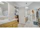 Bright, tiled bathroom features a large vanity, sink, and access to bedroom at 4838 N Tioga Way, Las Vegas, NV 89149