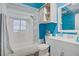 Bathroom features a shower over tub, white marble-style tiles, and white sink vanity at 4838 N Tioga Way, Las Vegas, NV 89149