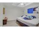 Bedroom with laminate floors, a tray ceiling, and a window with blue coverings at 4838 N Tioga Way, Las Vegas, NV 89149