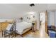 Bright bedroom with hardwood floors and minimalist decor; door to another room at 4838 N Tioga Way, Las Vegas, NV 89149