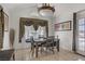 Dining room with a large window, decorative curtains, and a dining table with chairs at 4838 N Tioga Way, Las Vegas, NV 89149