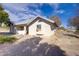 A vintage home boasts a charming exterior with a window unit and simple yard at 4838 N Tioga Way, Las Vegas, NV 89149