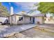 Exterior of a cozy home featuring a concrete driveway, a front door, and a charming facade at 4838 N Tioga Way, Las Vegas, NV 89149