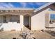 Classic home entrance featuring a quaint front door, stone pathway, and visible house number at 4838 N Tioga Way, Las Vegas, NV 89149