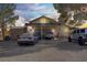 Exterior of home featuring a carport with multiple vehicles and a gravel driveway at 4838 N Tioga Way, Las Vegas, NV 89149