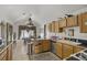 A kitchen with stainless steel appliances, an island, and a view of a table next to a window at 4838 N Tioga Way, Las Vegas, NV 89149