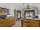 A kitchen with a vaulted ceiling, tile floors, an island, and a dining table next to a window at 4838 N Tioga Way, Las Vegas, NV 89149