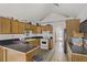 Kitchen with wooden cabinets, an island, stainless steel appliances, and a view of the backyard at 4838 N Tioga Way, Las Vegas, NV 89149