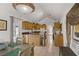 Open kitchen and dining area with an island, wooden cabinets, stainless steel appliances and bright light at 4838 N Tioga Way, Las Vegas, NV 89149