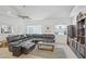 Cozy living room featuring a comfortable sectional sofa, media center, and lots of light at 4838 N Tioga Way, Las Vegas, NV 89149