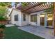 Cozy backyard with a covered patio, synthetic grass and desert landscaping at 5046 Great Abaco St, North Las Vegas, NV 89031