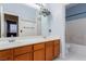 Bathroom featuring double sinks with wood cabinets and bathtub/shower combo at 5046 Great Abaco St, North Las Vegas, NV 89031
