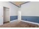 Bedroom with blue accent paint, neutral carpeting and a closet at 5046 Great Abaco St, North Las Vegas, NV 89031
