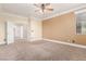 Spacious primary bedroom featuring neutral tones, crown molding, and a ceiling fan with light at 5046 Great Abaco St, North Las Vegas, NV 89031