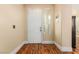 The entryway features hardwood floors, a white front door, and a slender window at 5046 Great Abaco St, North Las Vegas, NV 89031