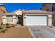 Charming single-story home features a two-car garage and desert landscaping for easy maintenance at 5046 Great Abaco St, North Las Vegas, NV 89031