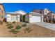 The home features a two-car garage and desert landscaping, perfect for low maintenance at 5046 Great Abaco St, North Las Vegas, NV 89031