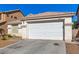 The front exterior shows a garage with a desert landscape and a glimpse of nearby houses at 5046 Great Abaco St, North Las Vegas, NV 89031