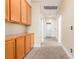 Well-lit hallway with carpet, wood cabinets, and white trim on walls and doors at 5046 Great Abaco St, North Las Vegas, NV 89031