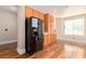 An airy kitchen area features wood flooring and stainless steel refrigerator at 5046 Great Abaco St, North Las Vegas, NV 89031
