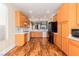Bright kitchen features stainless steel appliances, stylish countertops, and wood flooring at 5046 Great Abaco St, North Las Vegas, NV 89031