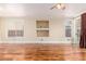 Sunlit living room featuring hardwood floors, built-in shelving, and backyard access at 5046 Great Abaco St, North Las Vegas, NV 89031