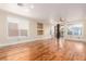 Bright and airy living area featuring hardwood floors and sliding glass doors to the backyard at 5046 Great Abaco St, North Las Vegas, NV 89031