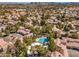 Aerial view showcasing a community pool and red tiled roofs, surrounded by lush greenery and trees at 5250 S Rainbow Blvd # 2046, Las Vegas, NV 89118
